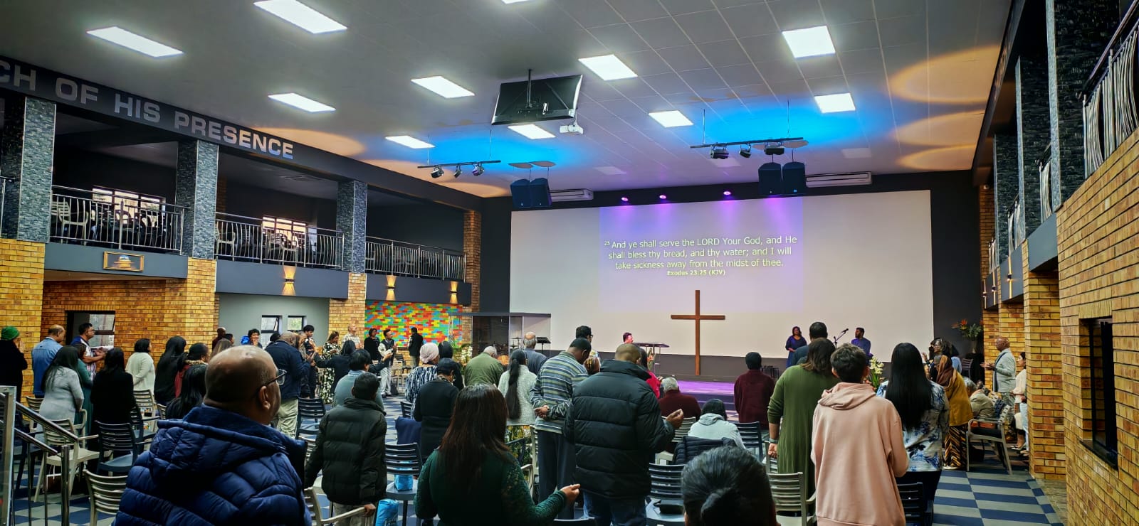 The congregation of Jacob's Well Ministries standing in worship in the sanctuary